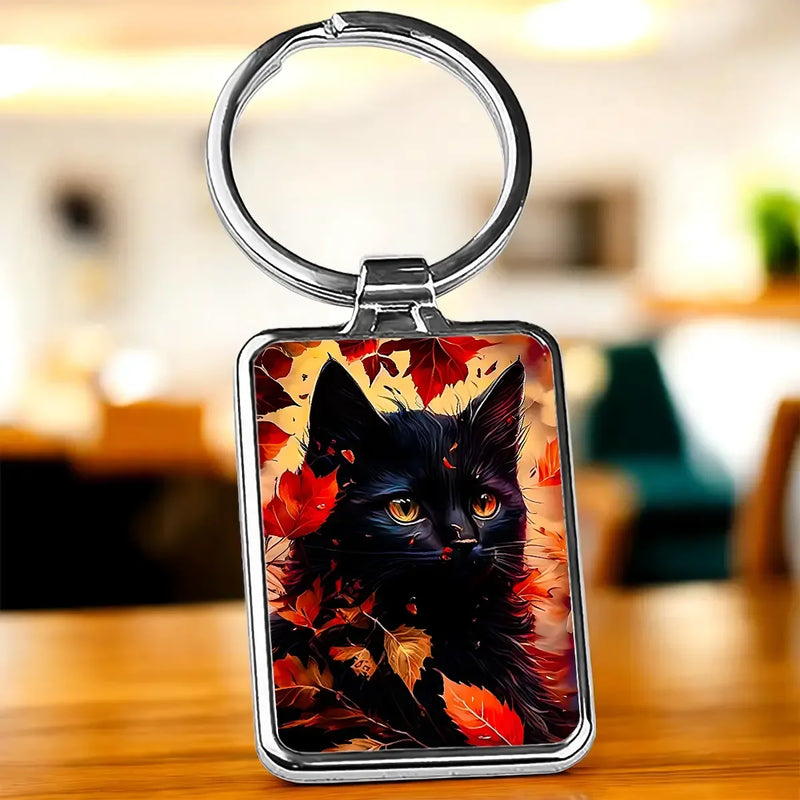Porte-clé chat automne : chat noir aux yeux dorés et feuilles d’automne