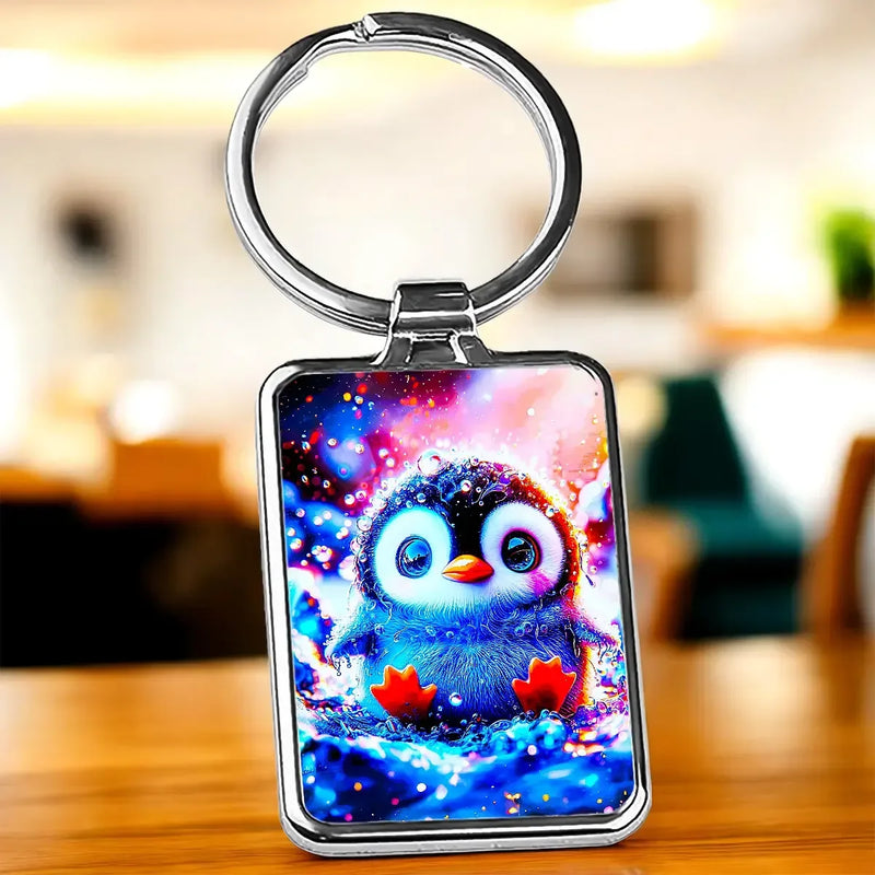 Porte-clé Petit Pingouin : pingouin bleu mignon sur fond cosmique coloré